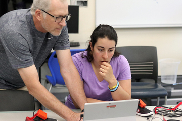 Jeff Bauer and Emma Madonna look at data.